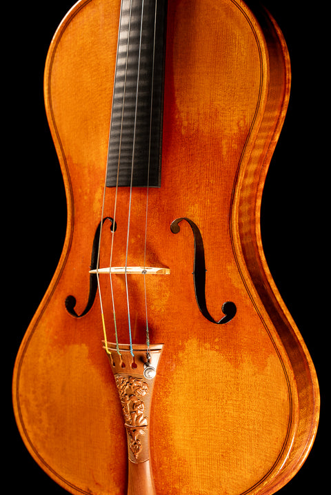 A cornerless violin featuring a Mountain Mahogany “Messiah” tailpiece.