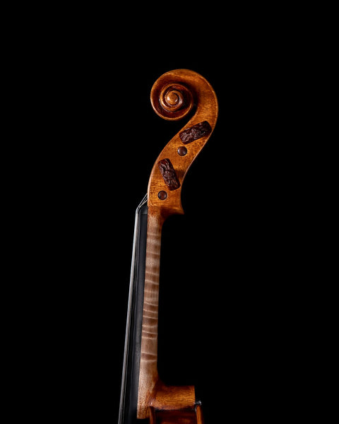 A violin featuring a fusion of Stradivari and Amati scrolls
