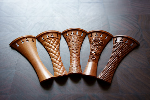 A variety of Hellweg & Cloutier violin tailpieces in Mountain Mahogany.